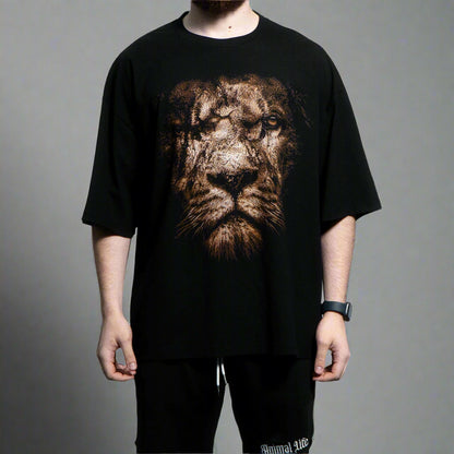 Person wearing a black t-shirt with a lion graphic design on a gray background